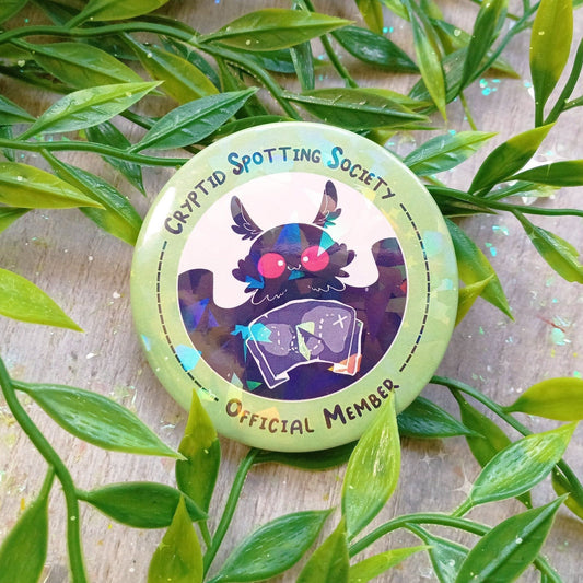 Insignia holográfica de la Sociedad de avistamiento de críptidos de Mothman